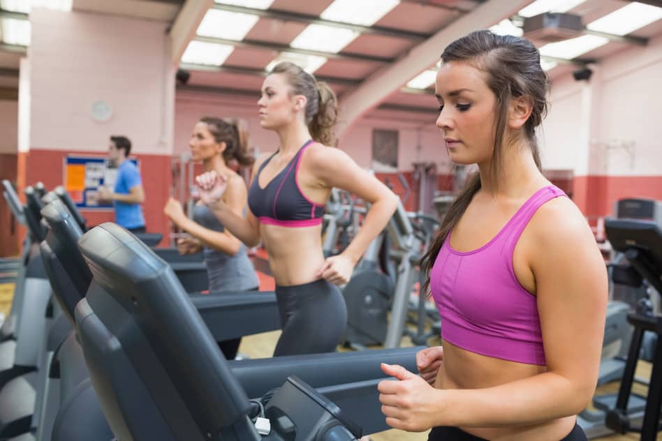 Women exercising on treadmills in the gym.