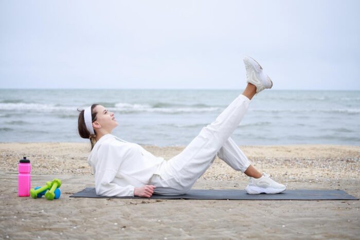 7-BestHip-Flexor-Exercises-young-beautiful-girl-laying-yoga-mat-raised-her-leg-high-quality-photo